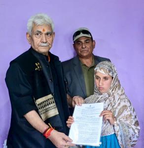 LG Manoj Sinha hands over job letter to wife of p...