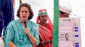 Priyanka Gandhi Vadra cleads from front and is ba...